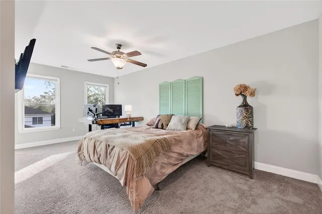 a bathroom with a granite countertop sink toilet and mirror