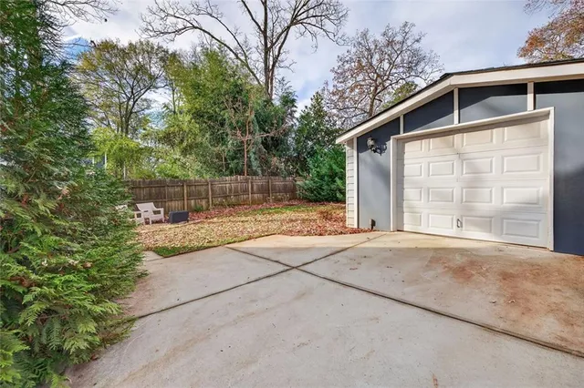 a backyard of a house with table and chairs