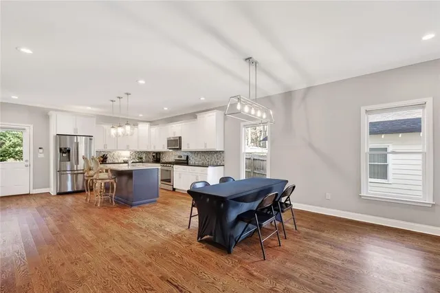 a view of a dining room with furniture window and wooden floor