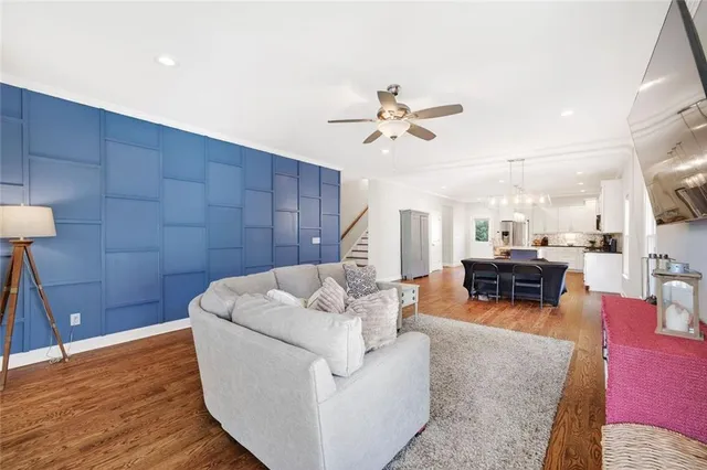 a living room with furniture and wooden floor