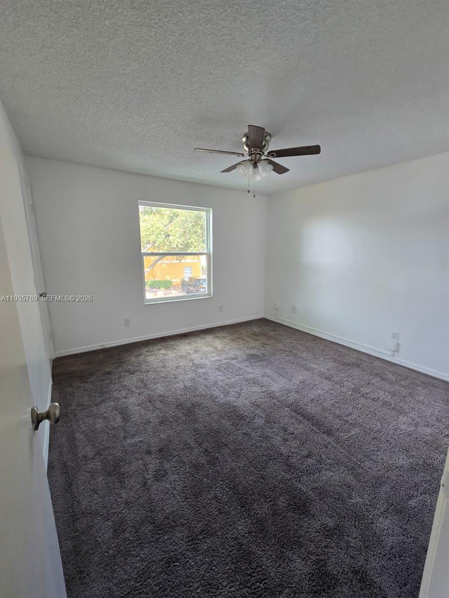4518 Commander Drive, Unit 1928 Orlando, FL 32822 - Photo 11 of 16 an empty room with windows and ceiling fan
