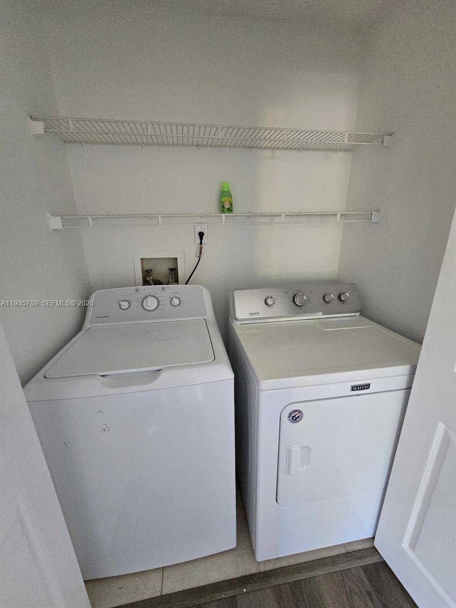4518 Commander Drive, Unit 1928 Orlando, FL 32822 - Photo 12 of 16 a utility room with dryer and washer