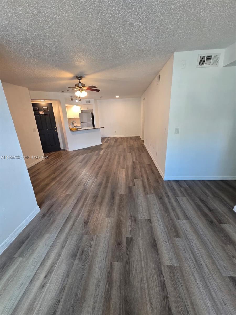 4518 Commander Drive, Unit 1928 Orlando, FL 32822 - Photo 14 of 16 a view of empty room with wooden floor