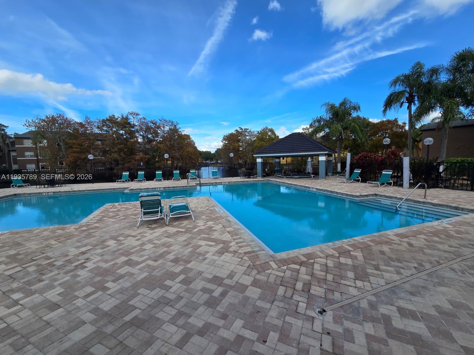 4518 Commander Drive, Unit 1928 Orlando, FL 32822 - Photo 3 of 16 a swimming pool with outdoor seating and yard