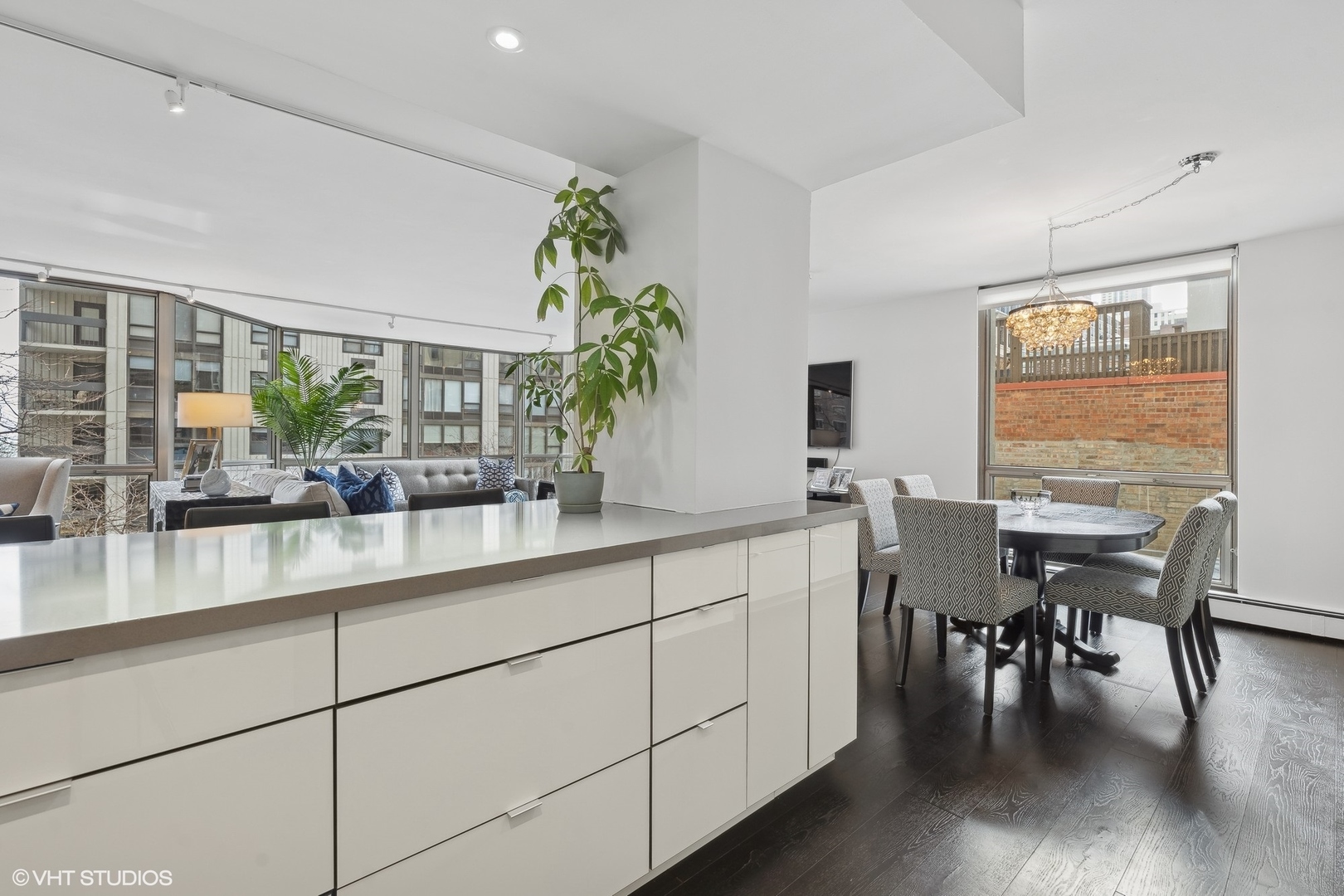 1310 North Ritchie Court, Unit 4C Chicago, IL 60610 - Photo 14 of 28 a dining hall with stainless steel appliances kitchen island granite countertop a table chairs in it and wooden floor