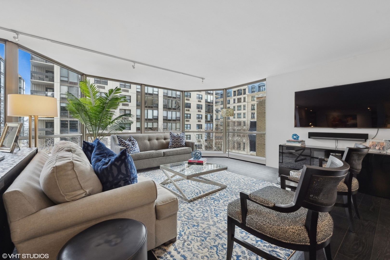 1310 North Ritchie Court, Unit 4C Chicago, IL 60610 - Photo 4 of 28 a living room with furniture a flat screen tv and a large window