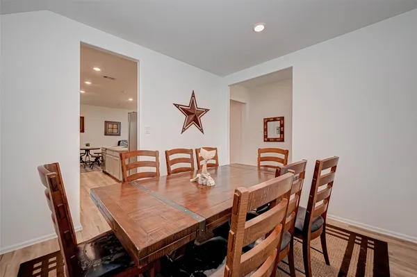 a view of a dining room with furniture and wooden floor