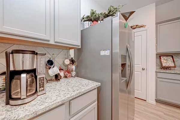 a kitchen with granite countertop a refrigerator stove and sink
