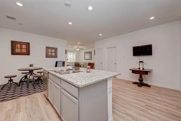 a kitchen with sink refrigerator and microwave