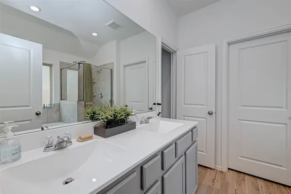 a bathroom with a tub a sink and a mirror