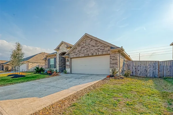 a view of a house with a yard and garage