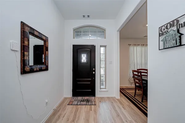 a view of a livingroom with wooden floor and staircase