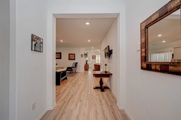 a living room with furniture and a wooden floor