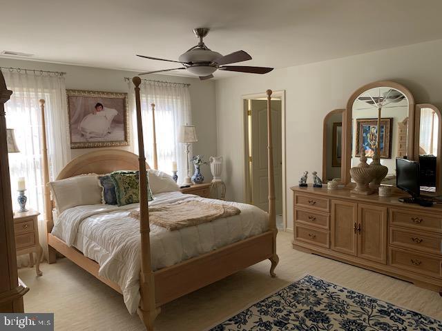 12 Pendleton Court Medford, NJ 08055 - Photo 23 of 24 a bedroom with a large bed and a chandelier