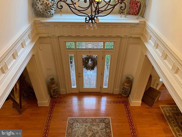 12 Pendleton Court Medford, NJ 08055 - Photo 4 of 24 a view of a hallway with wooden floor and a chandelier