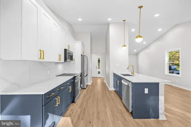 a kitchen with kitchen island a sink stove and wooden cabinets