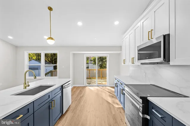 a kitchen with a sink stove and microwave