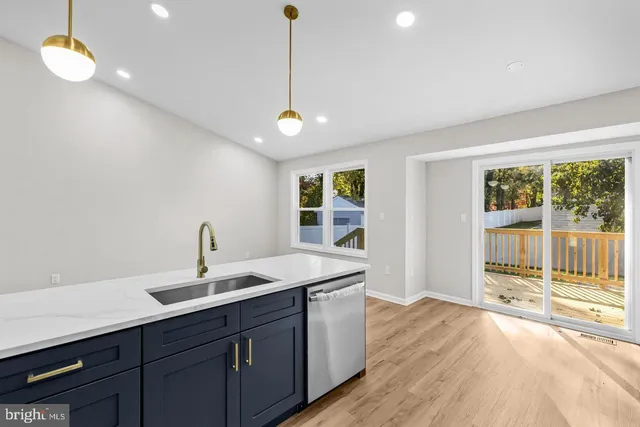 a kitchen with a sink appliances and a large window