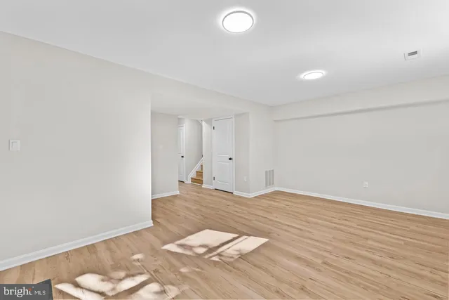 a view of an empty room and wooden floor