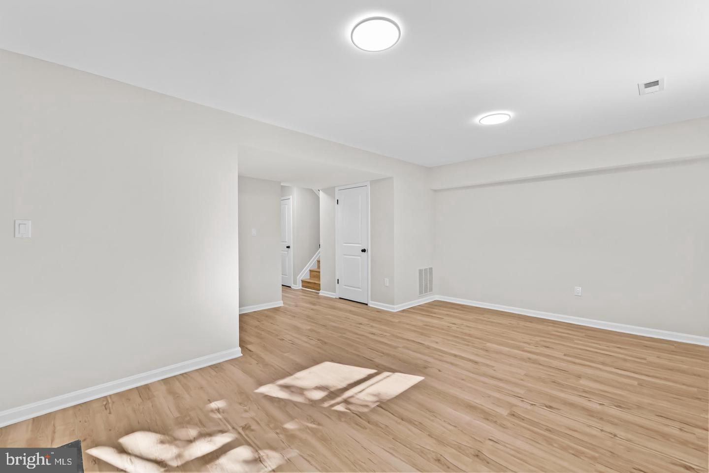 10290 South Grant Avenue Manassas, VA 20110 - Photo 30 of 41 a view of an empty room and wooden floor