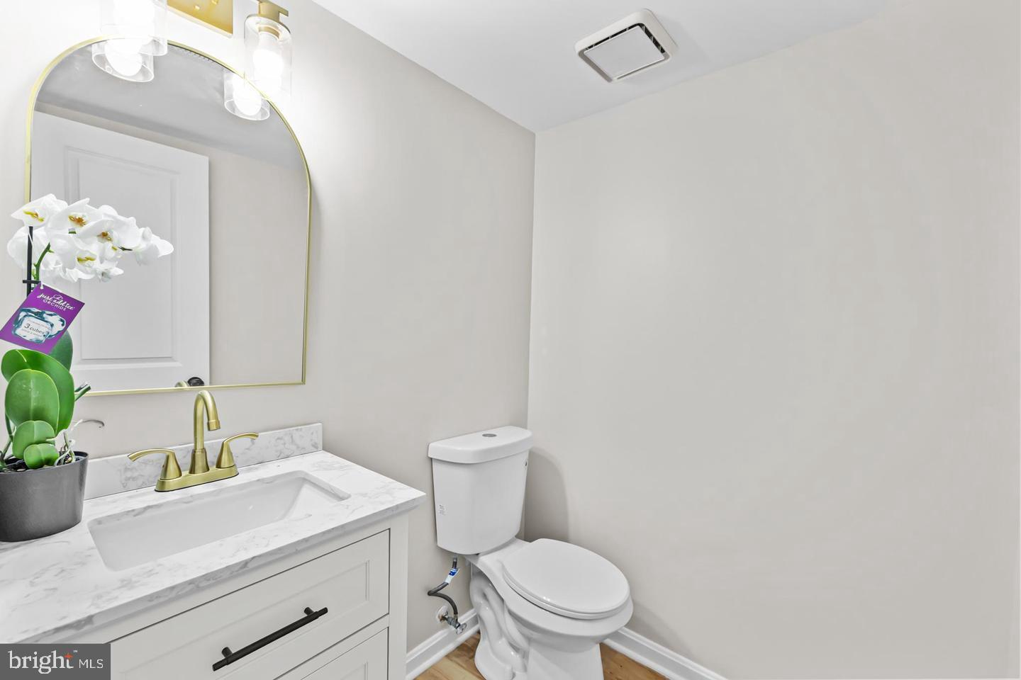 10290 South Grant Avenue Manassas, VA 20110 - Photo 31 of 41 a bathroom with a granite countertop sink mirror vanity and toilet