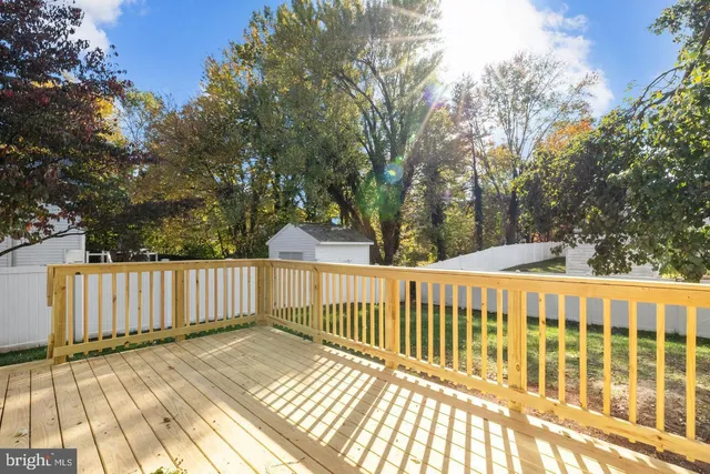 a view of balcony with wooden floor and fence