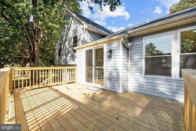 a view of a house with wooden deck