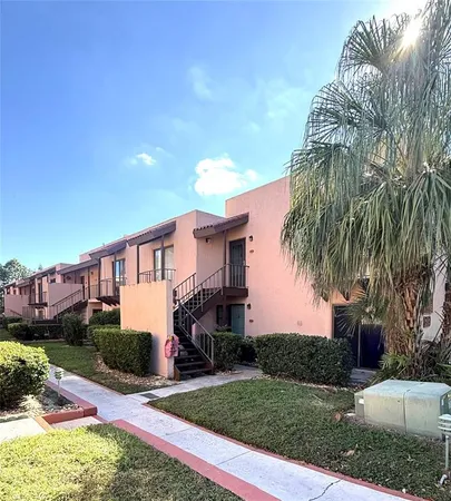 a front view of a house with a yard and potted plants