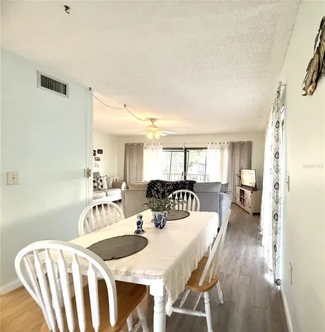 a view of a dining room with furniture and wooden floor