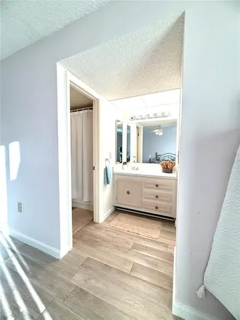a bedroom with a bed and a flat tv screen on dresser