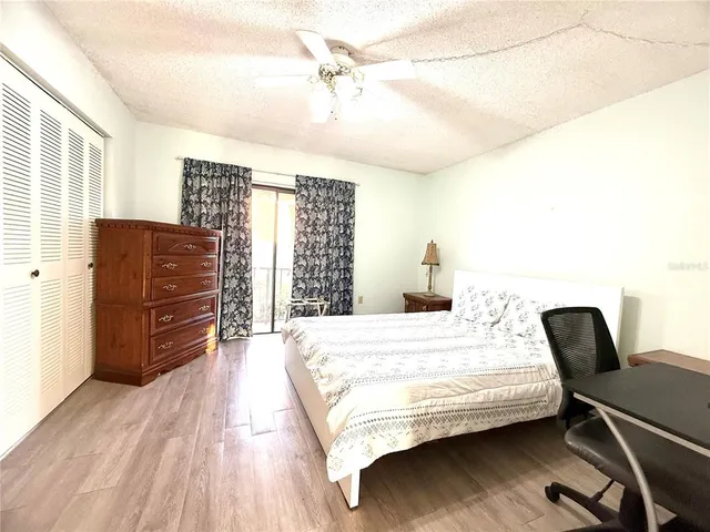 a spacious bathroom with a sink a toilet a mirror and shower