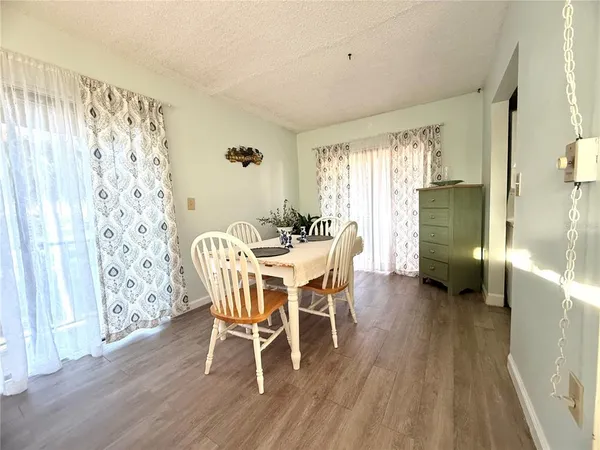 a view of a porch with furniture and wooden floor