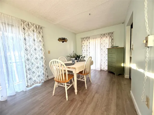 a view of a porch with furniture and wooden floor