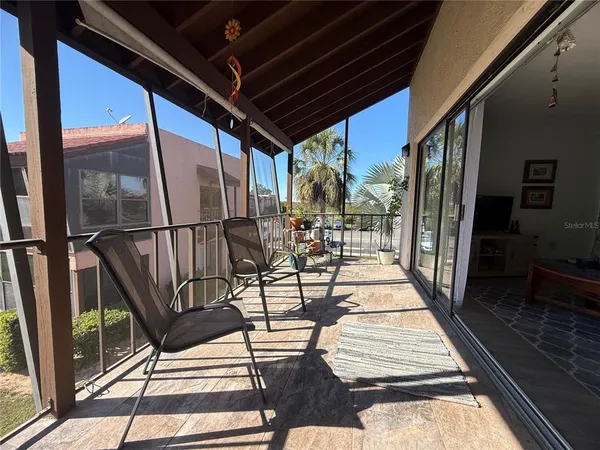 a view of a chairs and table in the balcony