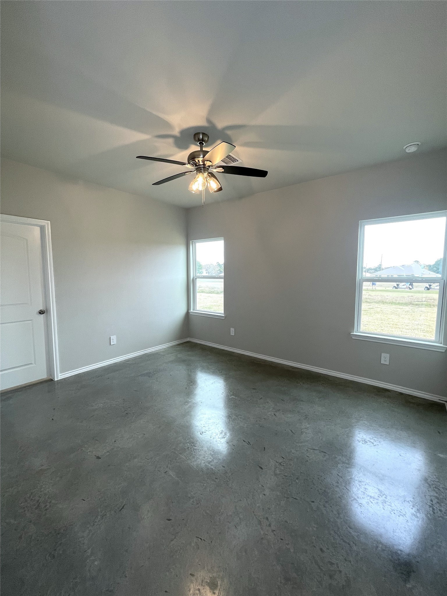 6 Greenway Drive Trinity, TX 75862 - Photo 12 of 28 an empty room with a window and a fan