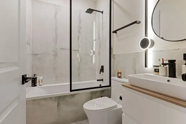 a bathroom with a sink a toilet and a mirror