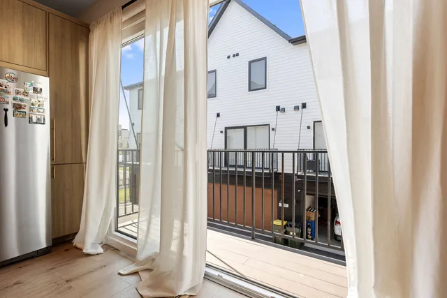 a view of a balcony with wooden floor and windows