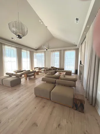 a living room with a flat screen tv and gym equipment