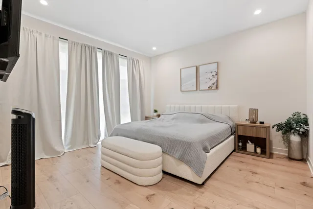 a spacious bedroom with a bed and a couch