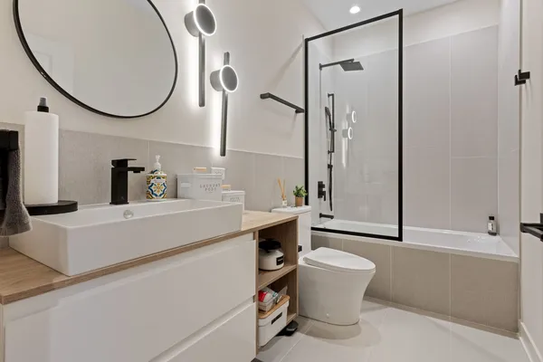 a bathroom with a sink a toilet and a mirror