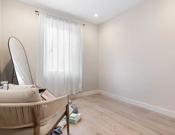 a room with a window and a wooden floor