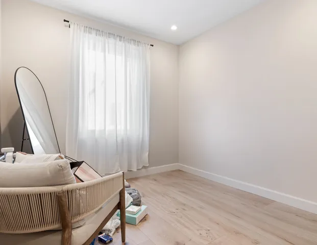 a room with a window and a wooden floor