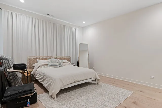 a bedroom with a bed and a mirror