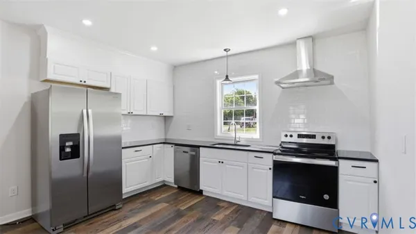 a kitchen with a sink stainless steel appliances and cabinets