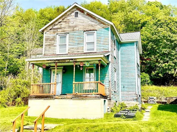 a view of a house with yard and sitting area