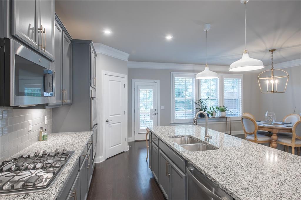 1367 Harris Way Street Brookhaven, GA 30319 - Photo 14 of 49 a kitchen with stainless steel appliances granite countertop a sink stove and refrigerator