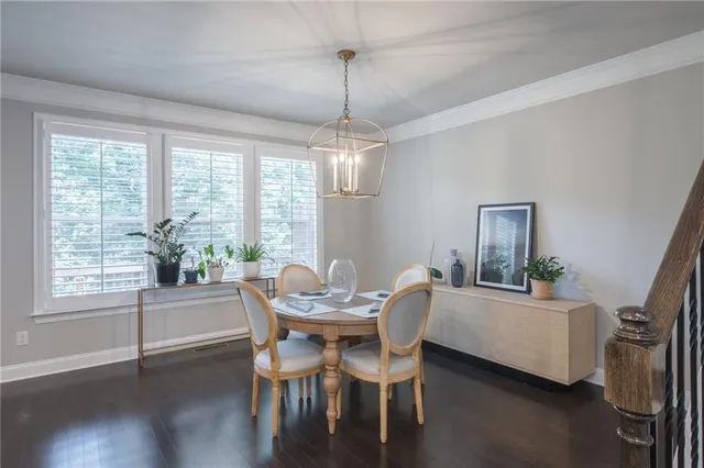 a dining room with furniture a chandelier and wooden floor