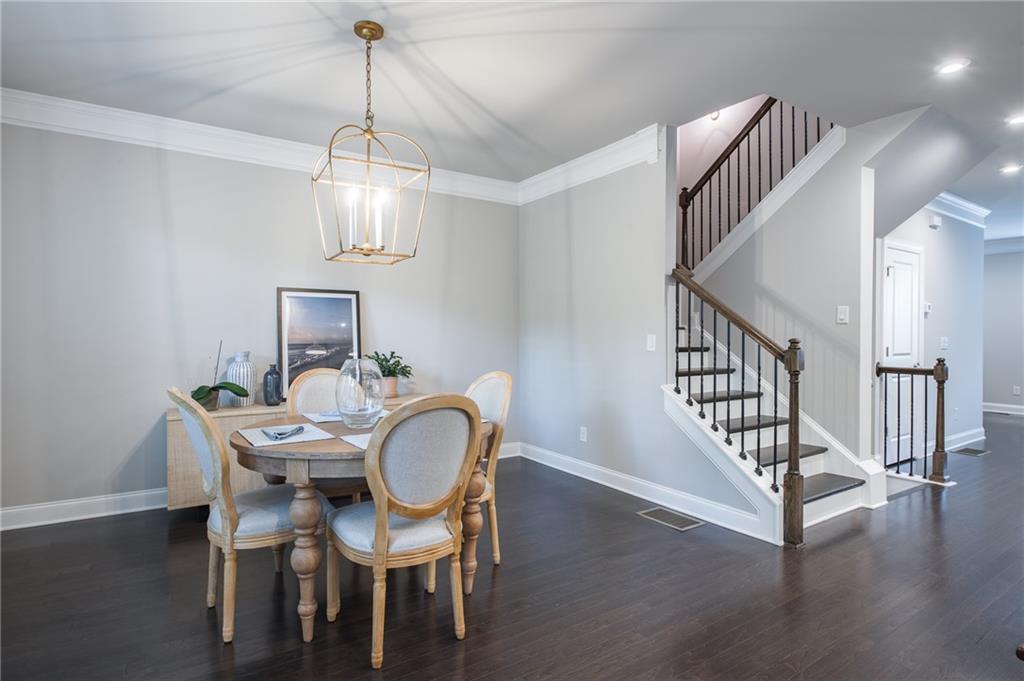 1367 Harris Way Street Brookhaven, GA 30319 - Photo 16 of 49 a view of a dining room with furniture a chandelier and wooden floor