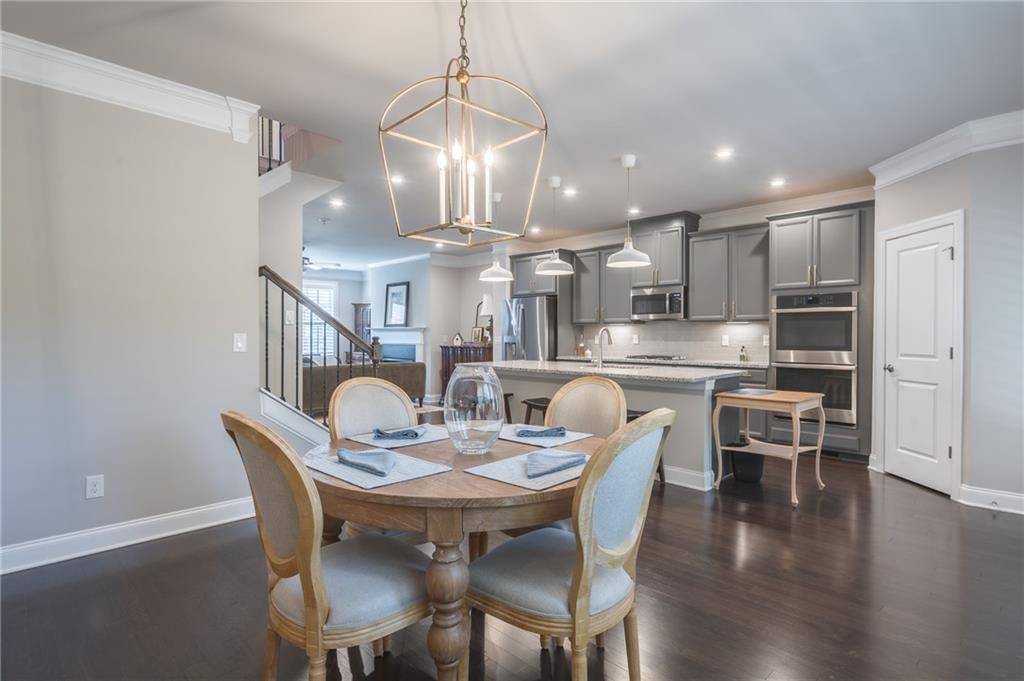 1367 Harris Way Street Brookhaven, GA 30319 - Photo 18 of 49 a view of a dining room and livingroom with furniture wooden floor kitchen view and chandelier