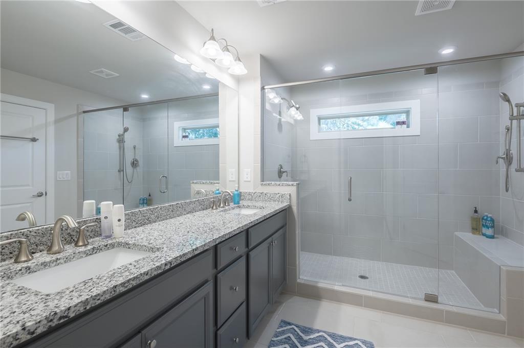 1367 Harris Way Street Brookhaven, GA 30319 - Photo 21 of 49 a bathroom with a granite countertop sink mirror and shower